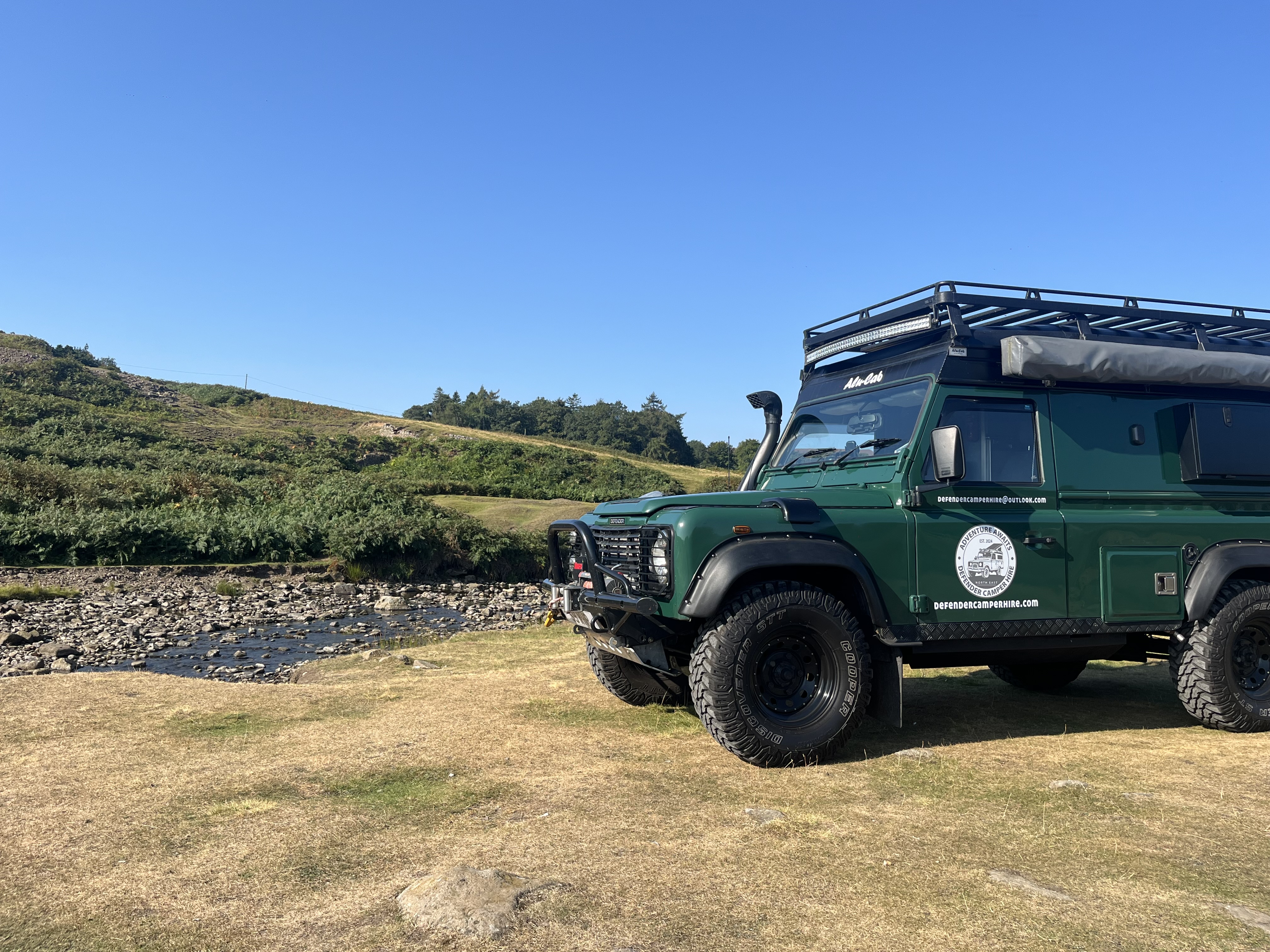 Land Rover Defender camper parked on the North East coast at dusk